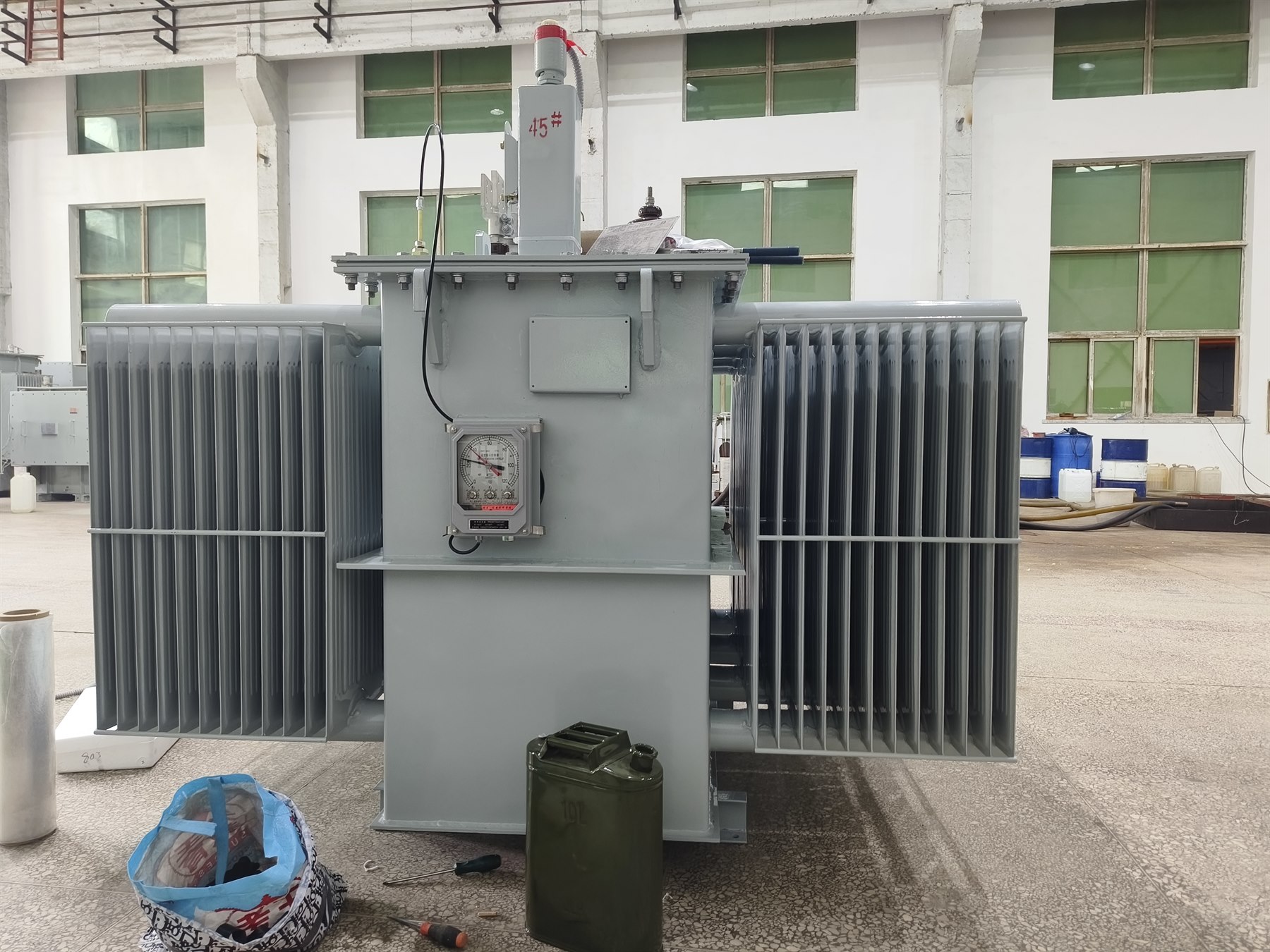 Hermetically sealed oil-immersed transformer operating at an industrial site