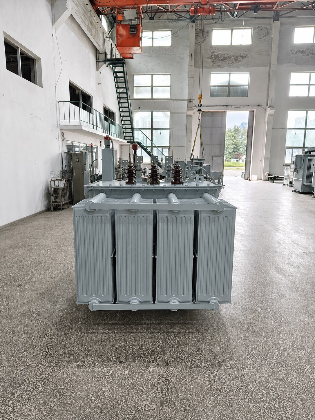 Hermetically sealed oil-immersed transformer inside a manufacturing workshop